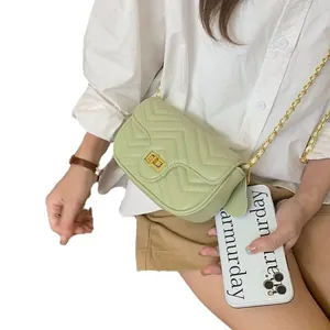 Stylish light green quilted crossbody bag with golden chain strap and chevron pattern