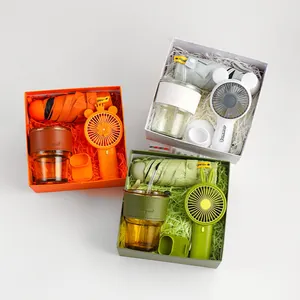 Business gift set with folding umbrella, handheld fan and glass cup in colorful boxes