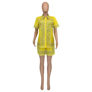 Detail view of the yellow paisley print two-piece set featuring short sleeves and shorts