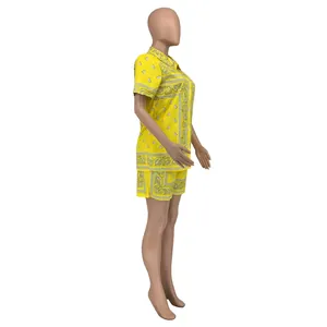 Detail of yellow women's two-piece paisley print shirt and shorts set on mannequin
