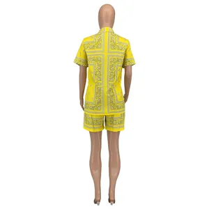 Rear view of women's yellow paisley print two-piece set with short sleeve shirt and shorts