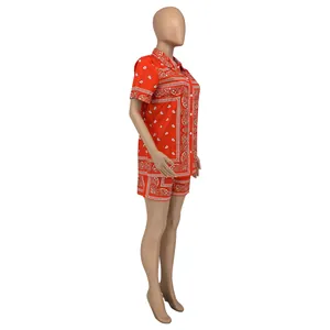Side view of red bandana paisley print shirt and shorts set on a mannequin