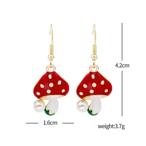Detail showing dimensions of red mushroom earrings with pearls and gold hooks