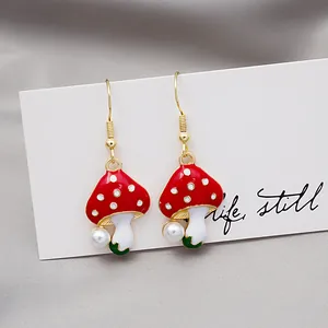 Cartoon mushroom drop earrings with red caps and pearls on gold hooks