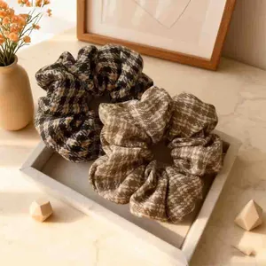 Set of two houndstooth plaid tweed hair scrunchies in classic brown and black tones