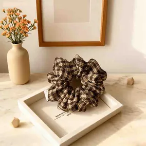 Elegant plaid scrunchie in deep brown and beige fabric for high ponytail styling