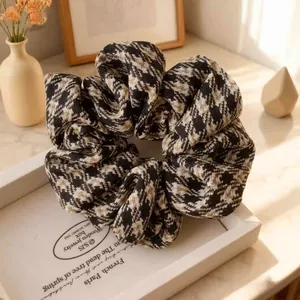 Close-up of houndstooth plaid scrunchie with high elasticity fabric on a display tray
