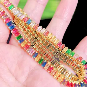 Macro shot of colorful baguette cut rainbow rhinestones on gold-plated link bracelet
