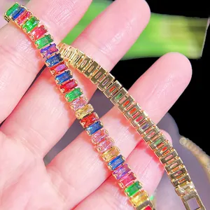 Close-up of gold chain bracelet with vibrant rectangular rainbow cubic zirconia stones