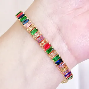 Macro detail of high-quality baguette-cut rainbow zircon stones on a gold-plated bracelet
