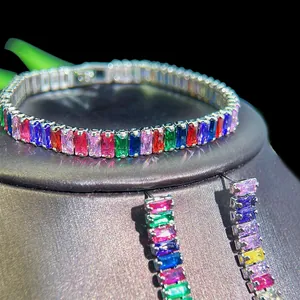 Detail of colorful rainbow gemstone bracelet and earrings set with silver-toned base