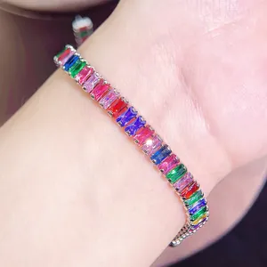 Close-up of a rainbow baguette-cut zircon bracelet on wrist with silver metal setting