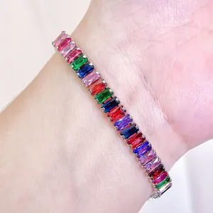 Macro shot of silver bracelet featuring baguette-cut multicolored zircon stones on wrist