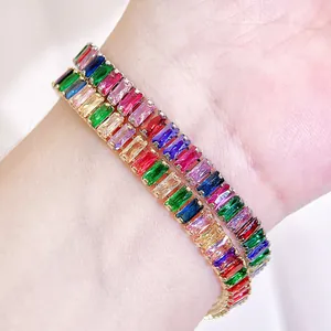 Macro detail of rainbow baguette cut zirconia tennis bracelets in gold plating