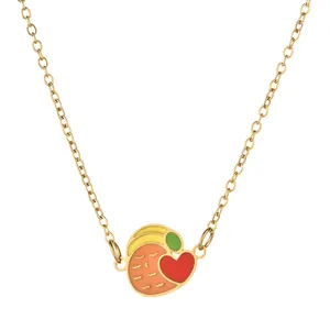 Detail of a gold-tone necklace featuring a colorful bird pendant with a red heart element