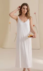 Detail of white cotton nightgown showing frilled hem and vertical pleated texture