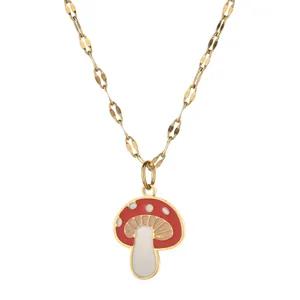 Close-up of a red and white mushroom pendant on a gold hollow oval link chain