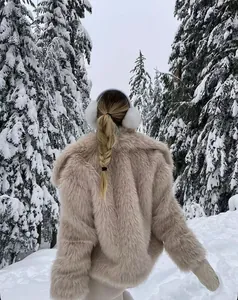 Dettaglio della soffice pelliccia sintetica di un caldo cappotto invernale sulla neve