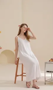 Detail of white cotton nightgown featuring delicate lace trim and soft wavy texture fabric