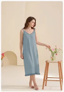 Detail of light blue cotton nightdress featuring ruffle straps and tassel hem detail