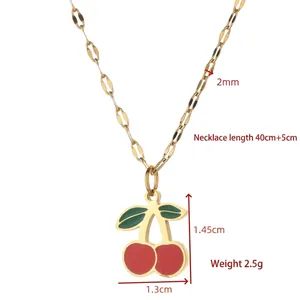 Cute cherry pendant necklace with red enamel fruit and green leaves in golden finish