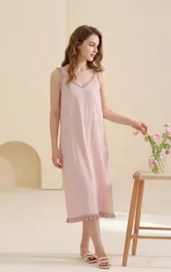 Detailed view of pink long cotton nightdress with ruffled V-neck and fringe hem