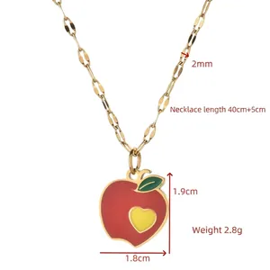 Gold-finish necklace with red apple pendant and yellow heart detail on a fine O-chain