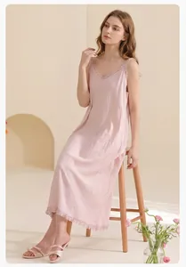 Detail of light pink cotton nightgown showing ruffle trim and soft pleated texture