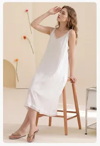 Detailed texture of white cotton nightgown featuring delicate lace trim and v-neckline