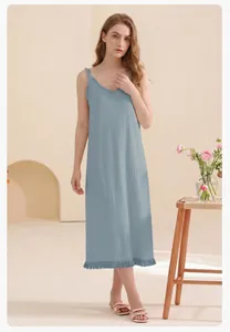 Detail of light blue cotton nightgown with V-neckline lace trim and pleated fabric texture