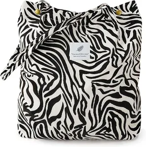 Minimalist corduroy tote bag with black and white zebra pattern and metal snap button