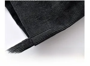 Detailed macro view showing the precise stitching and corduroy texture of the black bag