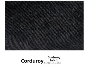 Macro close-up showing the soft vertical texture of black corduroy fabric on a tote bag