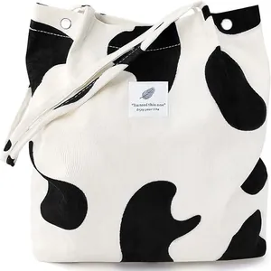 Large capacity corduroy tote bag for women featuring stylish black and white cow pattern