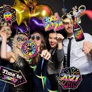 Cheerful group holding rainbow 2027 New Year party photo booth props and masks