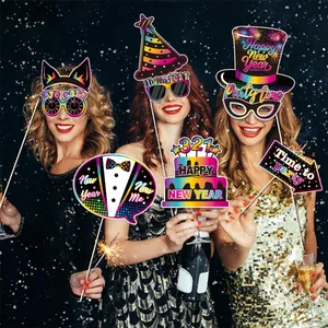 Detailed view of 2027 New Year party photo props held by people in a festive setting