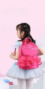 Detailed back view of girl's pink ruffled backpack with breathable mesh padding.