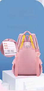 Pink nylon school backpack detail with thickened straps and integrated ID name tag