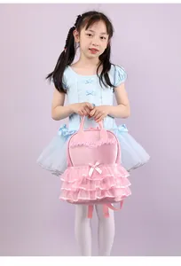 Sweet pink ruffled nylon girl's backpack held by a young dancer in a blue tutu dress