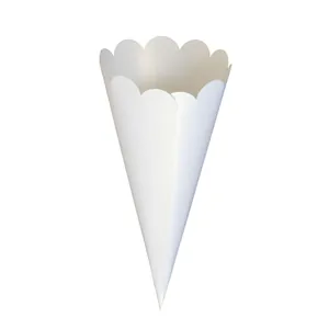 Close-up detail of a white paper confetti cone featuring elegant scalloped wavy edges.
