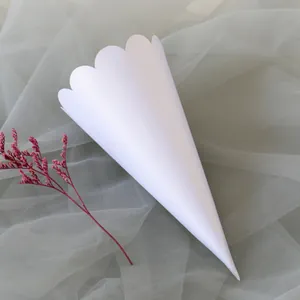 Detailed view of elegant white wedding confetti paper cone with scalloped wave edge