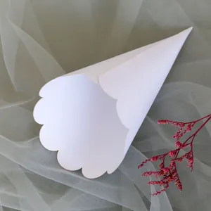 Close-up of white paper flower cone with elegant scalloped edges for wedding party decor