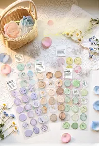 Detailed view showing translucent floral wax seal stickers in various pastel colors