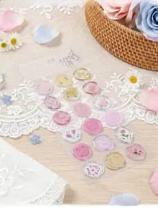 Detailed view of translucent floral wax seal stickers for envelope decoration and sealing