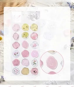 Close-up detail of translucent floral wax seal stickers for decorative stationery use