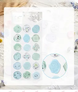 Detail view of translucent wax seal stickers with delicate floral and nature patterns