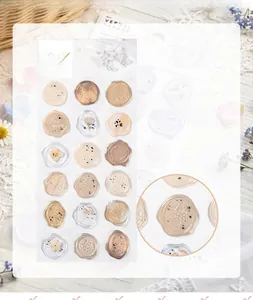 Close-up of translucent wax seal stickers with delicate floral patterns and metallic finish