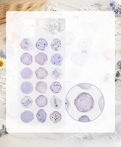 Detail view of translucent lavender faux wax seal stickers with floral patterns