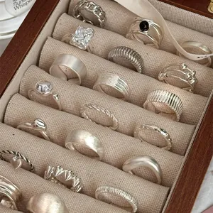 Collection of vintage S925 sterling silver rings in a wooden jewelry display box