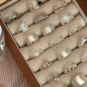 Collection of vintage S925 sterling silver rings featuring adjustable open band designs